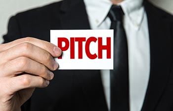 picture man holding paper with "pitch" word